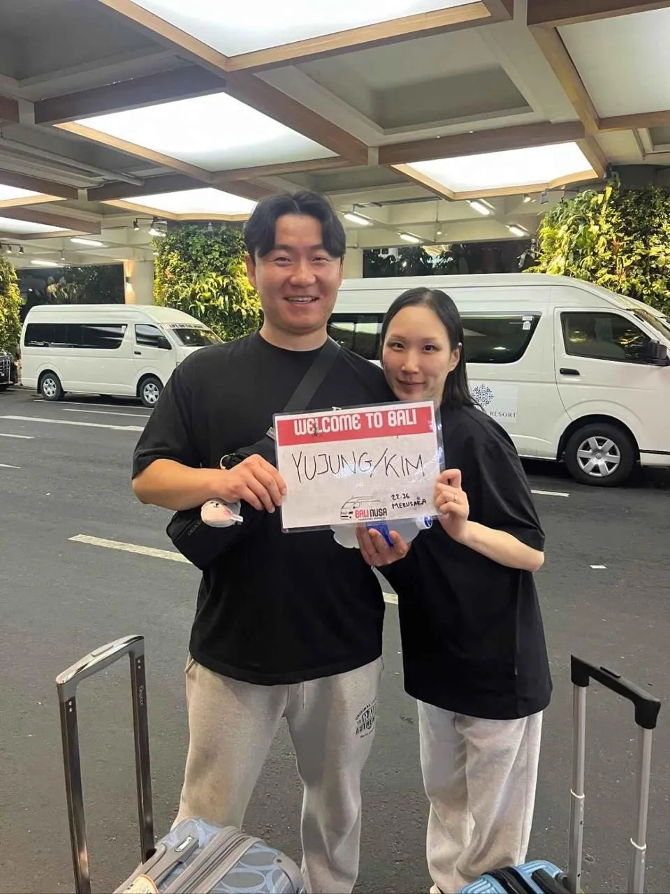 A professional driver greeting travelers upon their arrival in Bali.