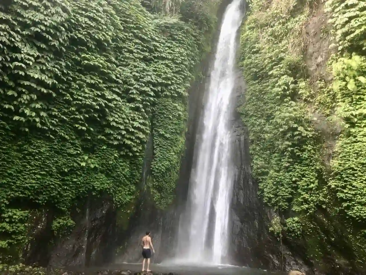 A spectacular hidden waterfall deep inside the foggy mountain jungles of Munduk Bali.