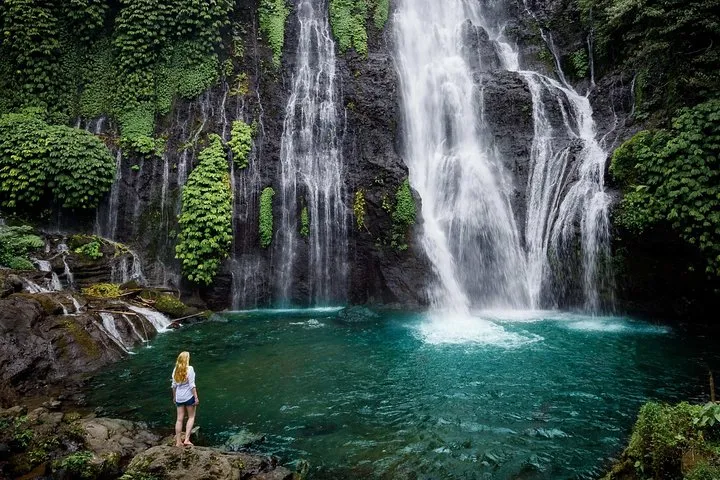 A hidden gem waterfall tucked away in Bali's lush tropical jungle.