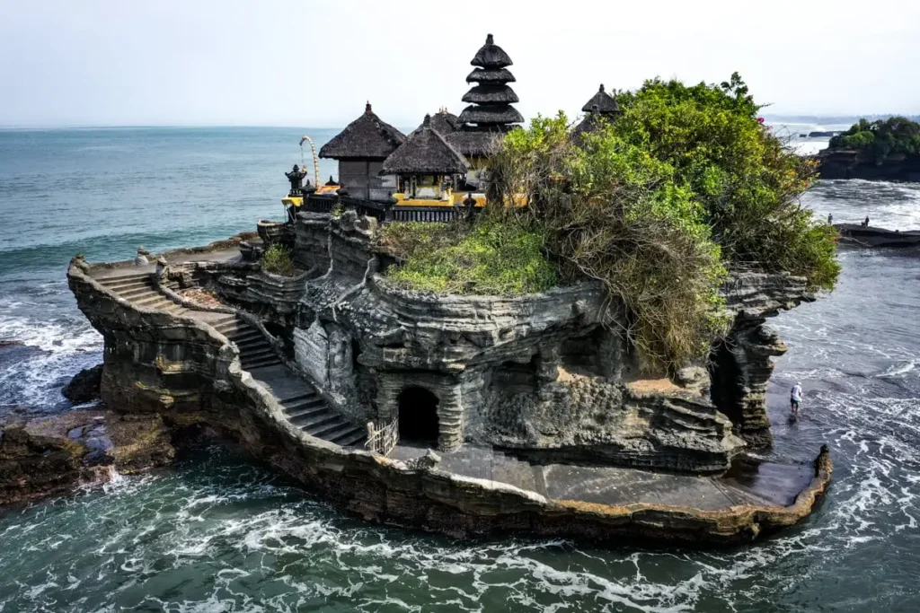 The iconic Tanah Lot Temple during a golden sunset, one of Bali's most famous landmarks.