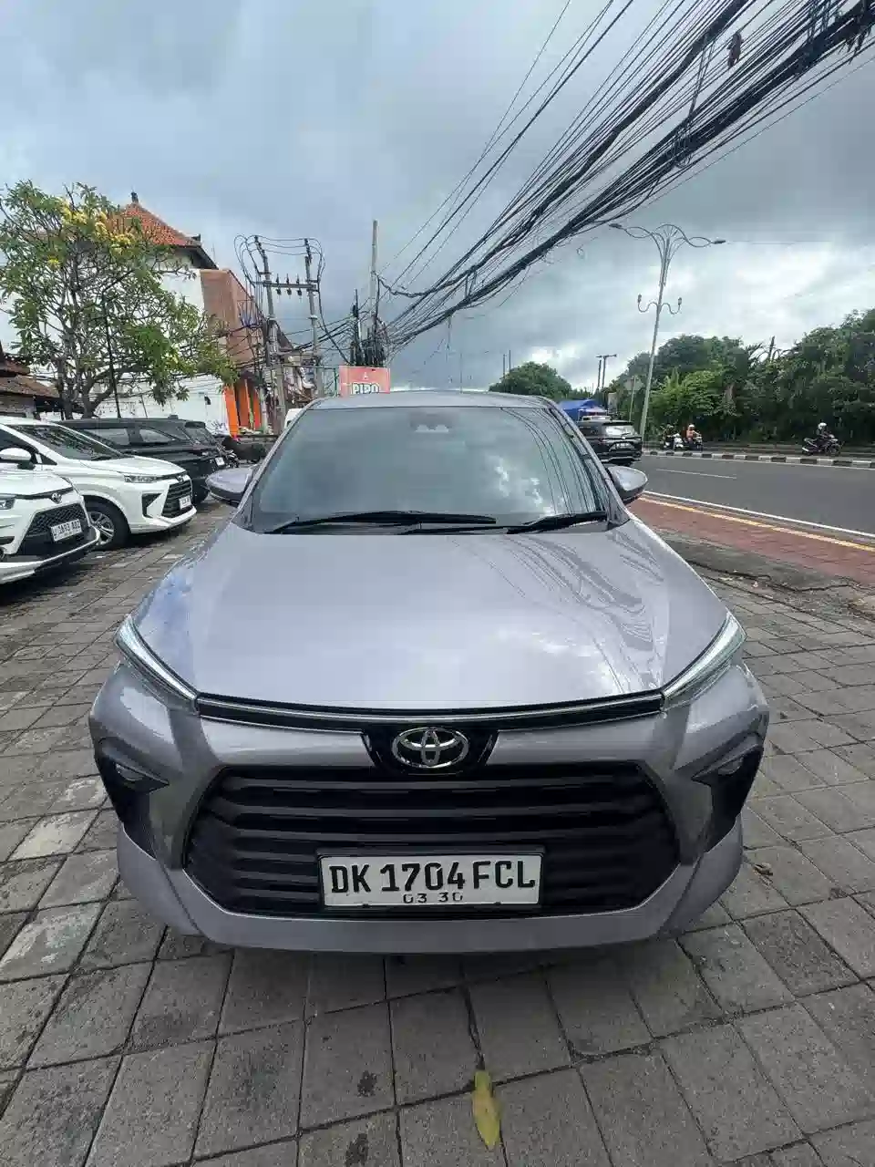A professional Bali private driver preparing the vehicle for a full-day tour.