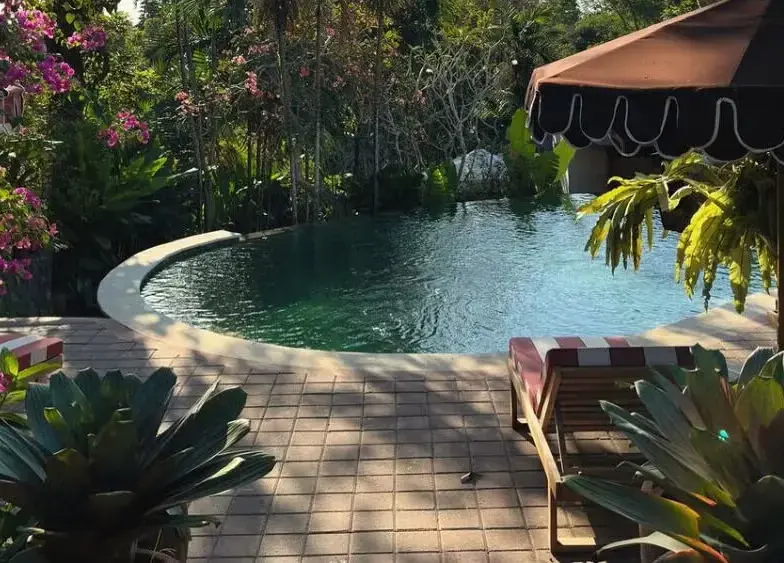 A peaceful traveler practicing morning meditation surrounded by lush green rice terraces in Bali.