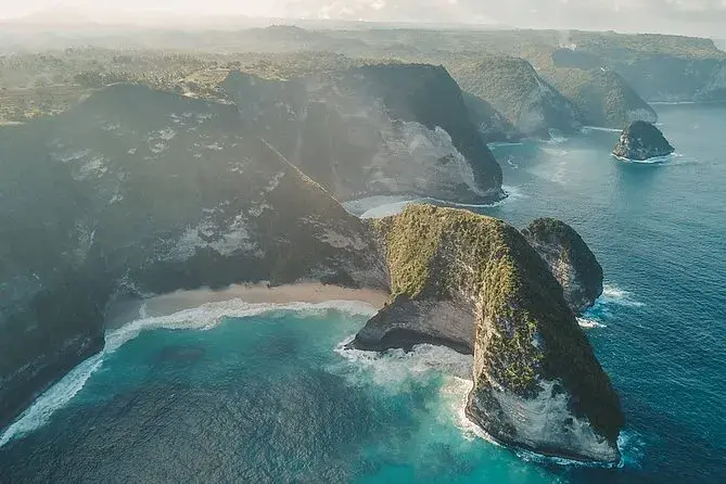 Dramatic coastline of Nusa Penida with limestone cliffs and turquoise water.