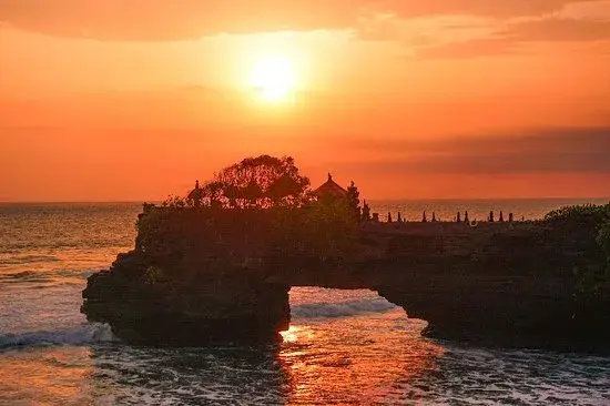 Tanah Lot Temple sunset golden hour.